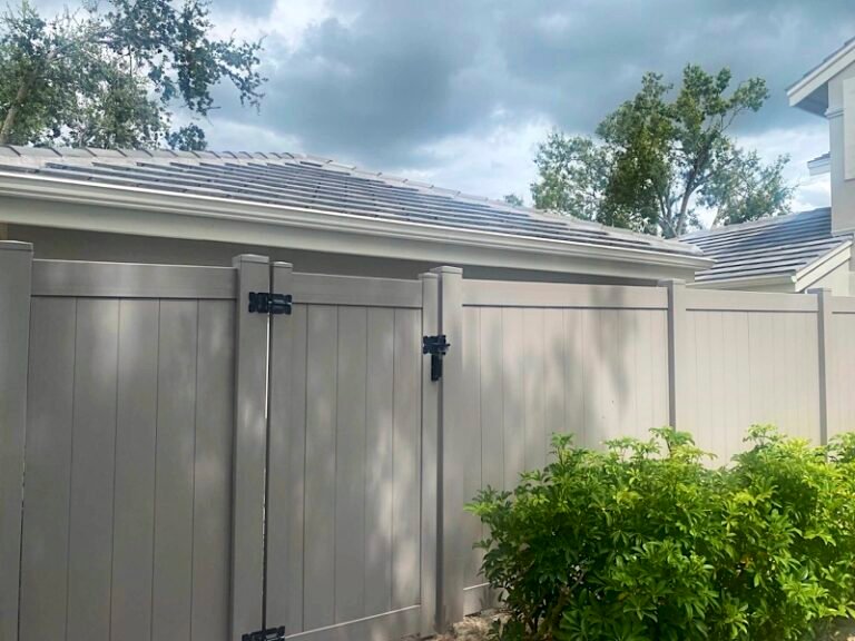 Tan vinyl privacy fence with walk gate