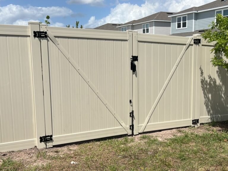 Tan vinyl privacy fence with double drive gate