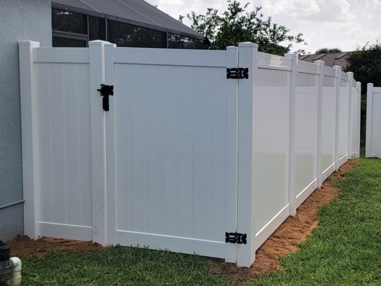 White vinyl privacy fence with gate installed by Sunstate Fence in Southwest Florida